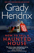 Hardback copy of "How to Sell a Haunted House" by Grady Hendrix, featuring the book cover with spooky haunted house illustration.