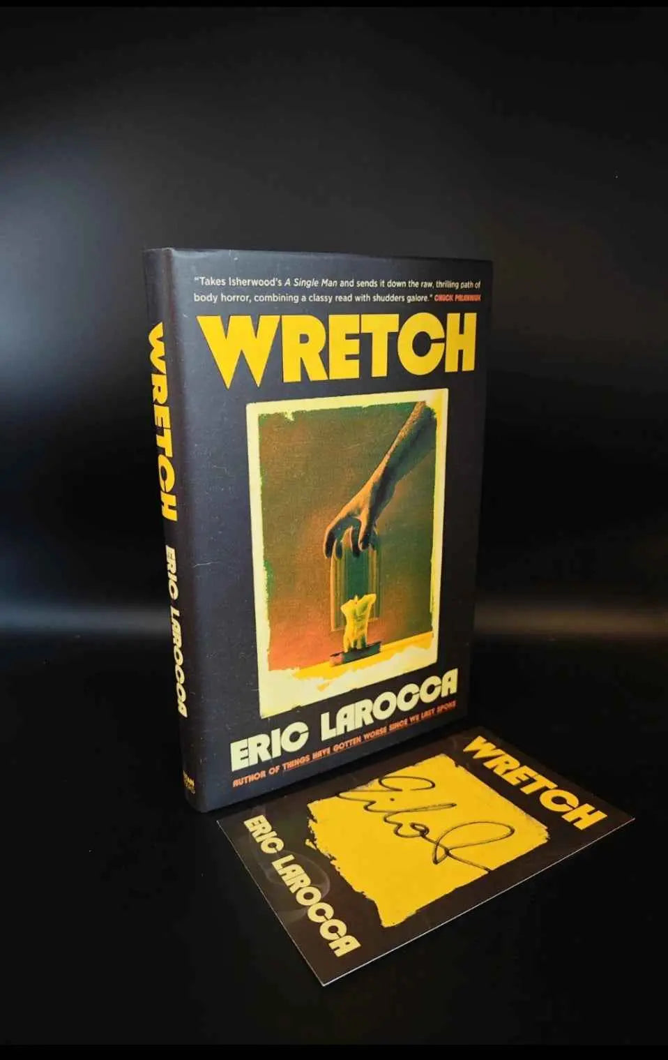 Hardback book titled "Wretch" by Eric LaRocca, featuring dark, moody cover art focused on grief and emotional support.