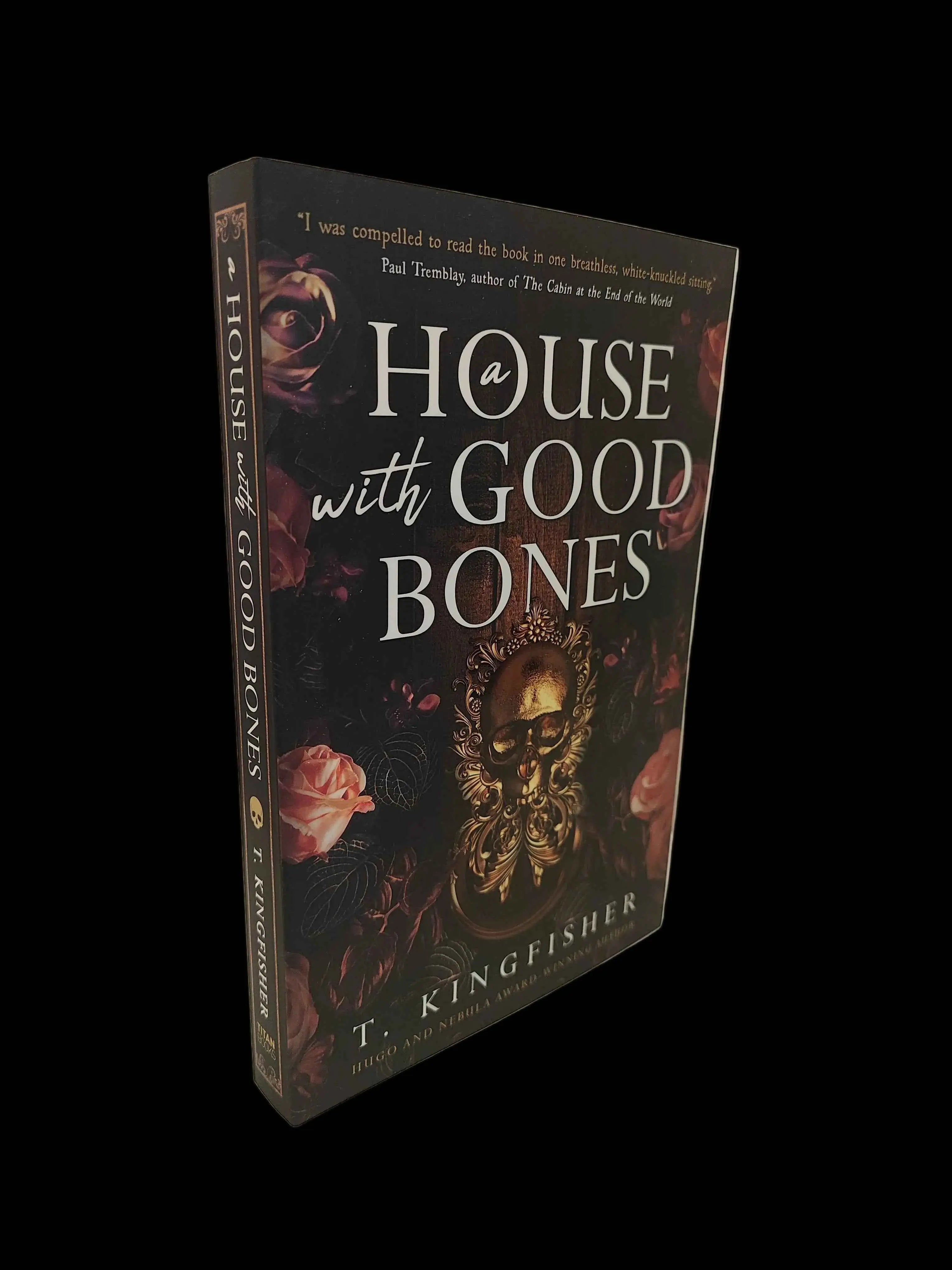 Paperback of "A House with Good Bones" by T. Kingfisher, featuring a cozy house illustration on the cover.
